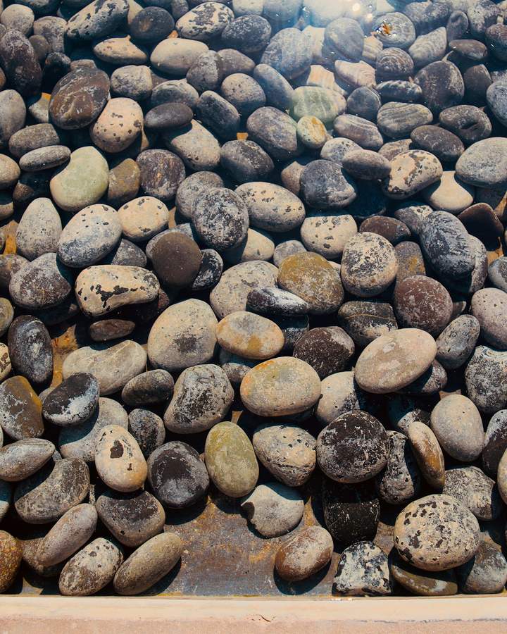 Close-up of smooth gray and tan river rock.